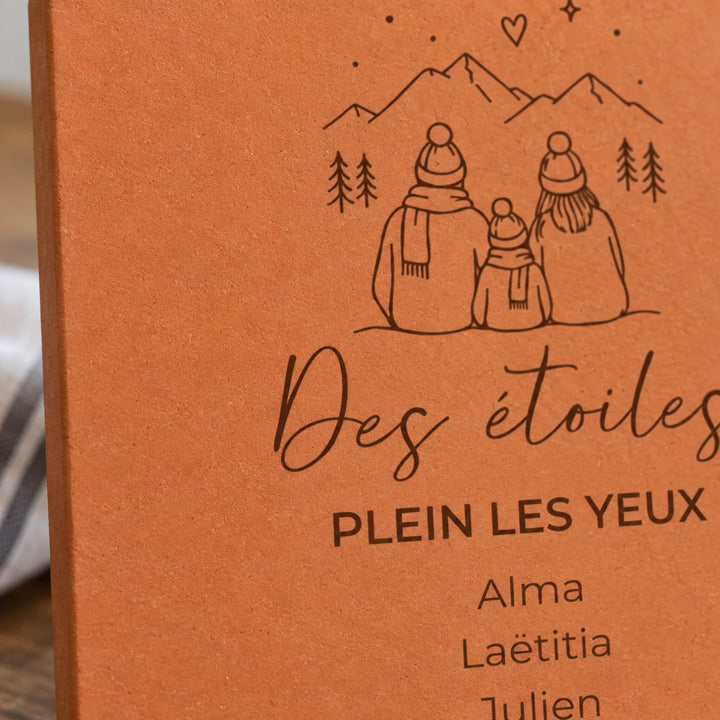 Détail de la famille devant les montagnes et des prénoms Alma, Laëtitia et Julien gravés.
