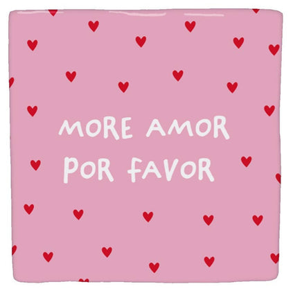 Pink “More amor por favor” decorative tile scattered with small red hearts, viewed from the front against a white background.