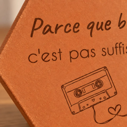 Close-up of the audio cassette, its heart-shaped tape and the message engraved on the terracotta tile.