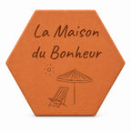 Cadeau de crémaillère porte-bonheur : tomette gravée « La Maison du Bonheur », parasol et chaise longue, sur fond blanc.