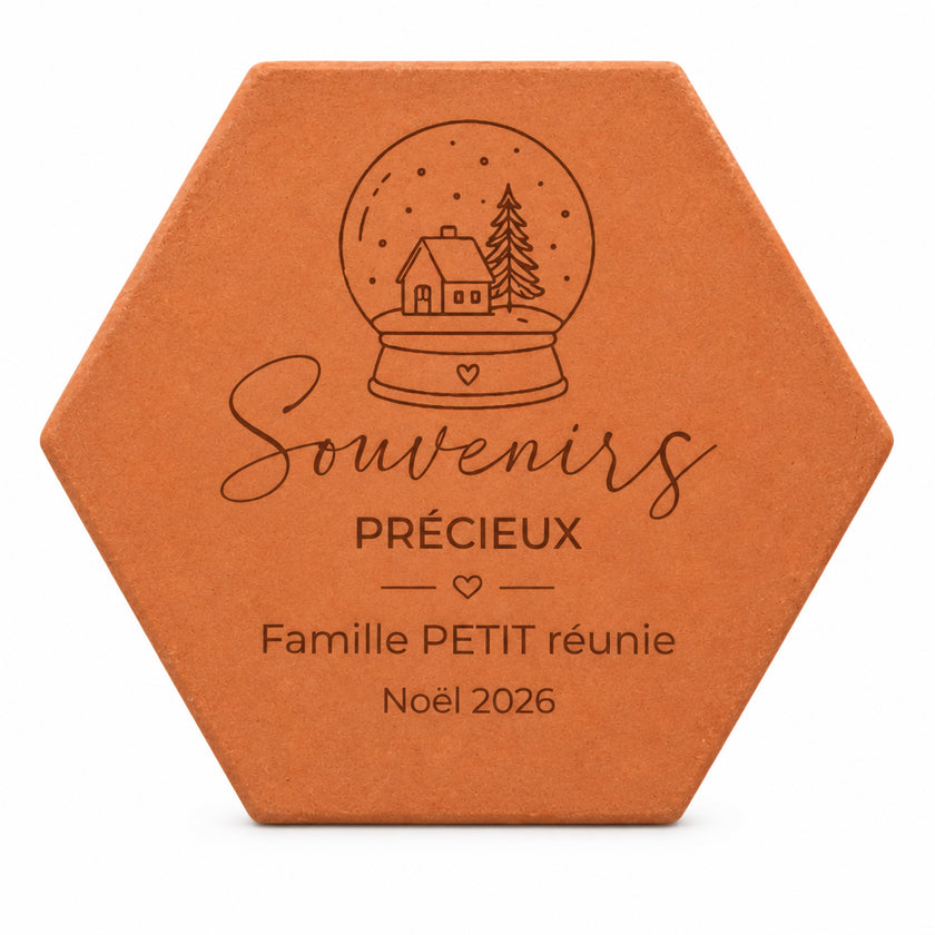 Personalised “Souvenirs précieux” Christmas terracotta tile, engraved with “Famille Petit” and a snow globe, on a white background.