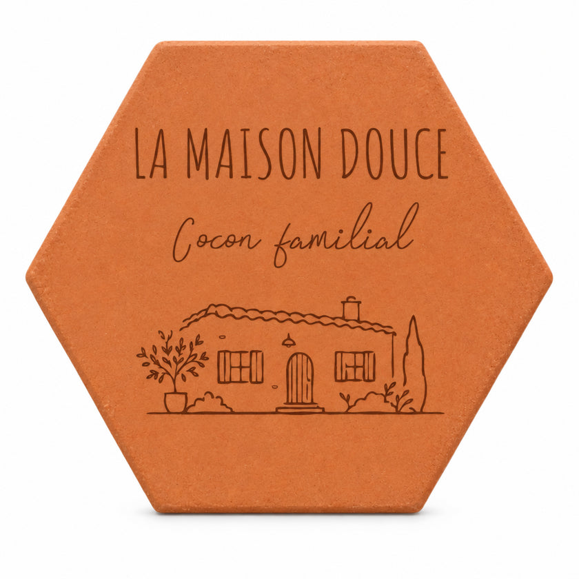 Personalised “La Maison Douce, Cocon familial” terracotta tile with an engraved house, on a white background.