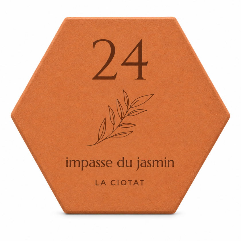 Salernes terracotta street plaque with a leafy sprig design, engraved with a number and street name — white background.