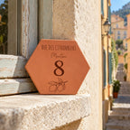 Personalised plaque engraved with “8 rue des Citronniers”, “Menton” and a lemon branch, resting on a stone windowsill in a lane.