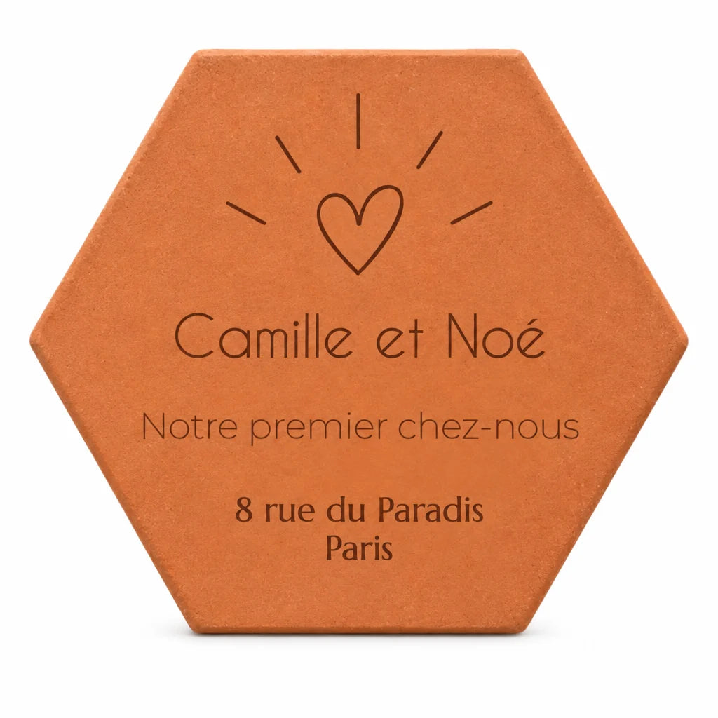 Cadeau de crémaillère pour un couple : tomette « Notre premier chez-nous », Camille et Noé, cœur et adresse gravés, sur fond blanc.